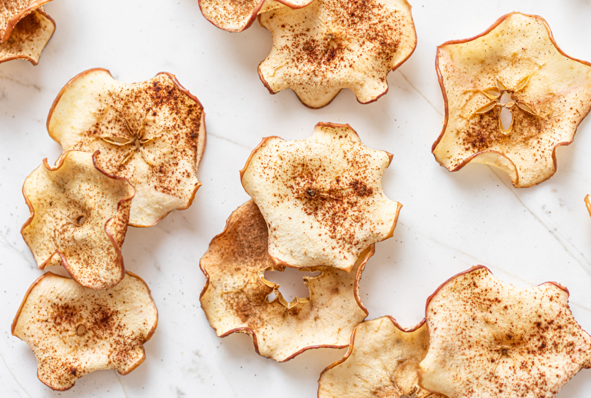 apple cinnamon chips scattered on a marble countertop 
