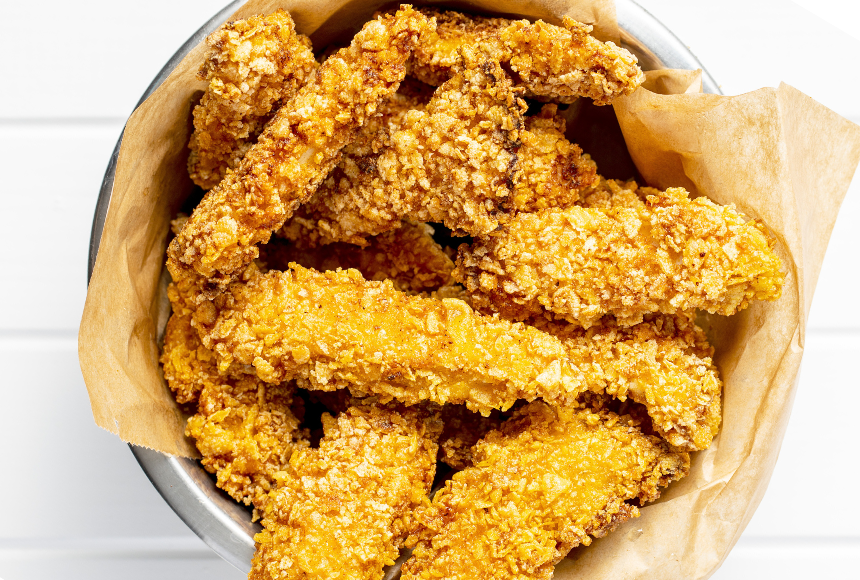 hemp chicken tenders displayed in a medium sized stainless steel bowl with a paper wrapper