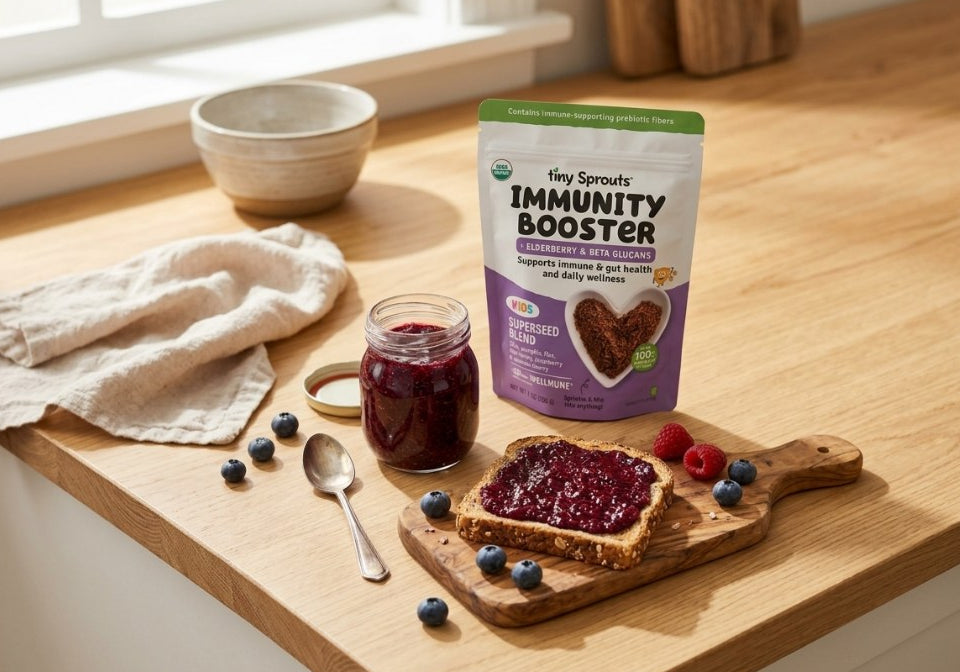 Berry Immune Boosting Jam in a jar with jam toast and a Tiny Sprouts Immunity Booster pouch on a kitchen counter