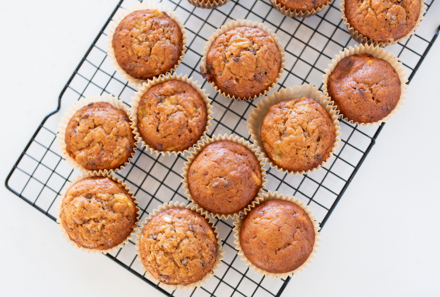 Zucchini and carrot muffins cooling on a baking tray 